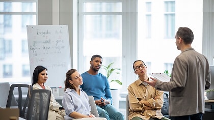 A person standing in front of a group of people